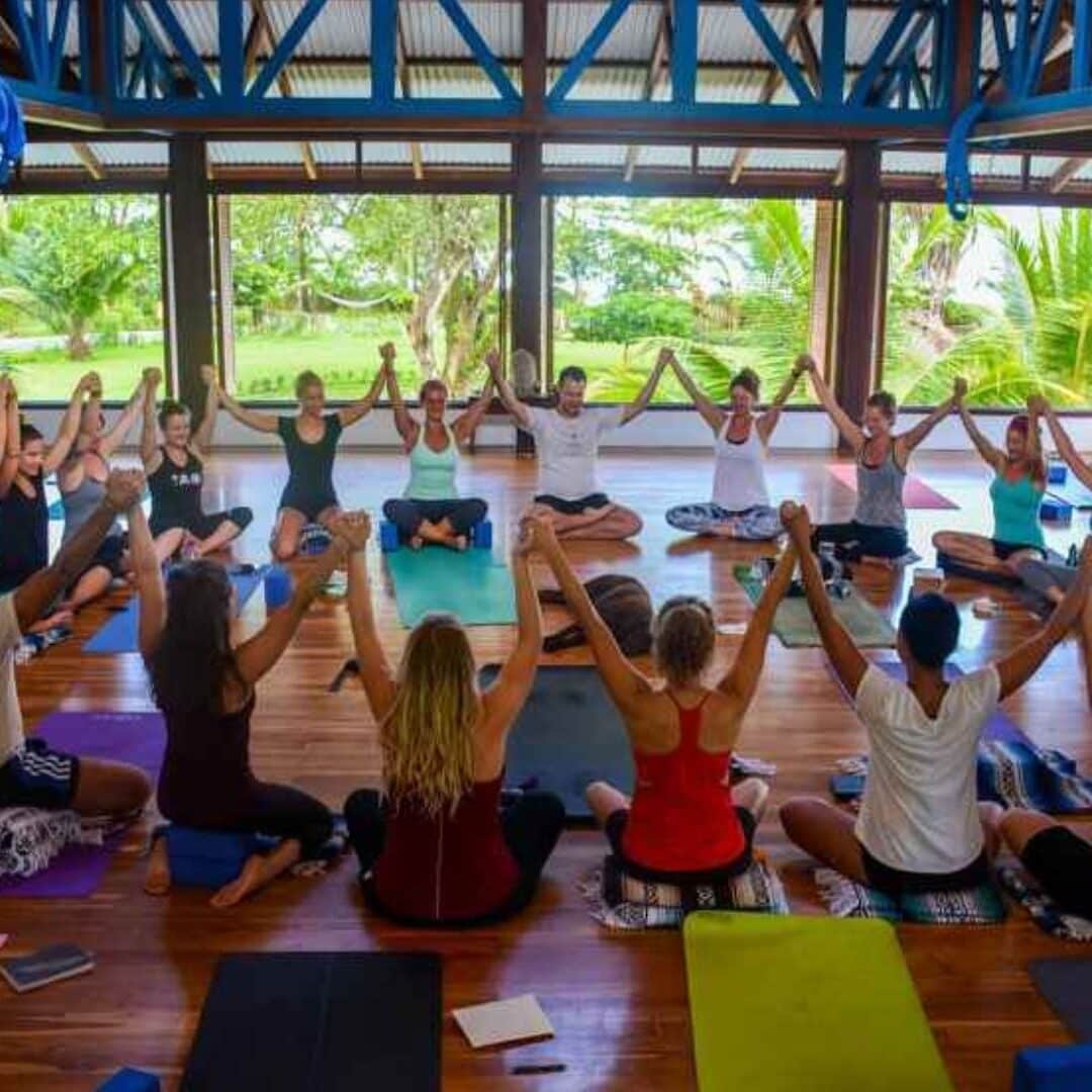 Yoga Teacher Training Participants sitting in a joyous circle in Blue Osa Yoga Retreat And Spa's yoga shala