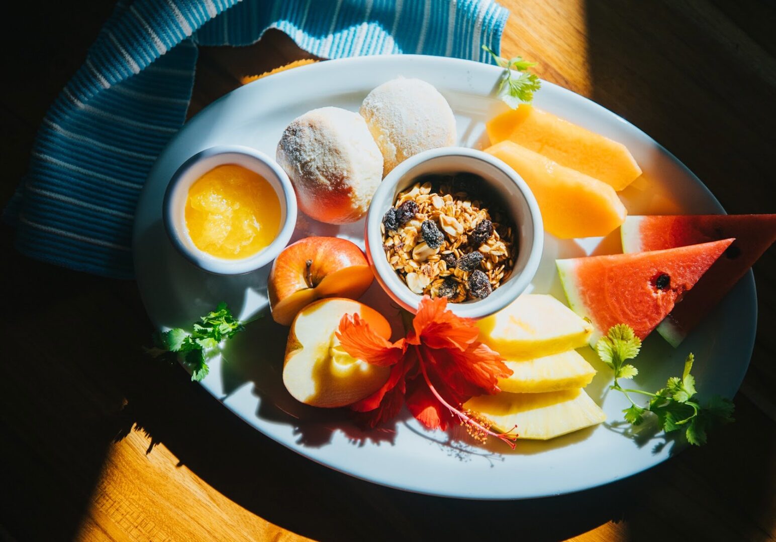 Blue Osa's breakfast plate with fresh fruit, granola, and scones.